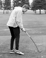 Rudy Moser tees off and gets a little bend from his club. Photo by Larry Stokke.