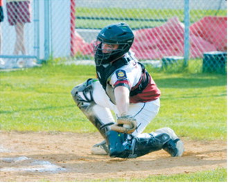 Landon Schneider gloves a pitch behind the plate for the Langdon Post 98 Red Sox Cardinals during a game against the May-Port-CG Patriots on June 8 in Mayville. Photo by Larry Stokke