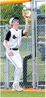 Tyson Gemmill makes a catch near the outfield fence for an out against Park River. Photo by Larry Stokke
