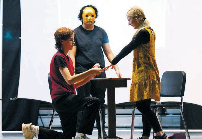 Michael St. John in his 20's, played by Oliver Lill, proposes to his girlfriend played by Maci Hoffarth. Photo by Larry Stokke.