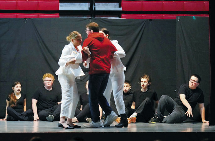 Melah Mackall and Kiera Lien (Assistant One and Two) force Michael to audit another life scenario. Photo by Larry Stokke.
