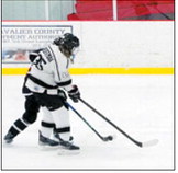Mya Hoffman tangles with an Oilers player for the control of the puck. Photo by Larry Stokke