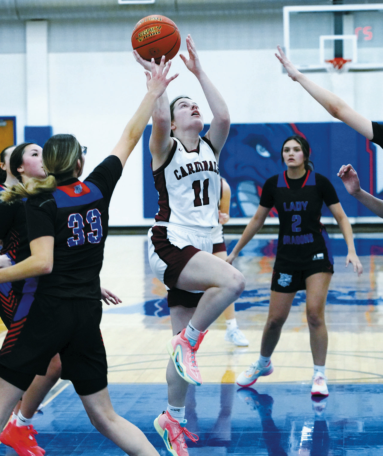 Erika Bakke drives into the paint and drops in a bucket. Photo by Larry Stokke.