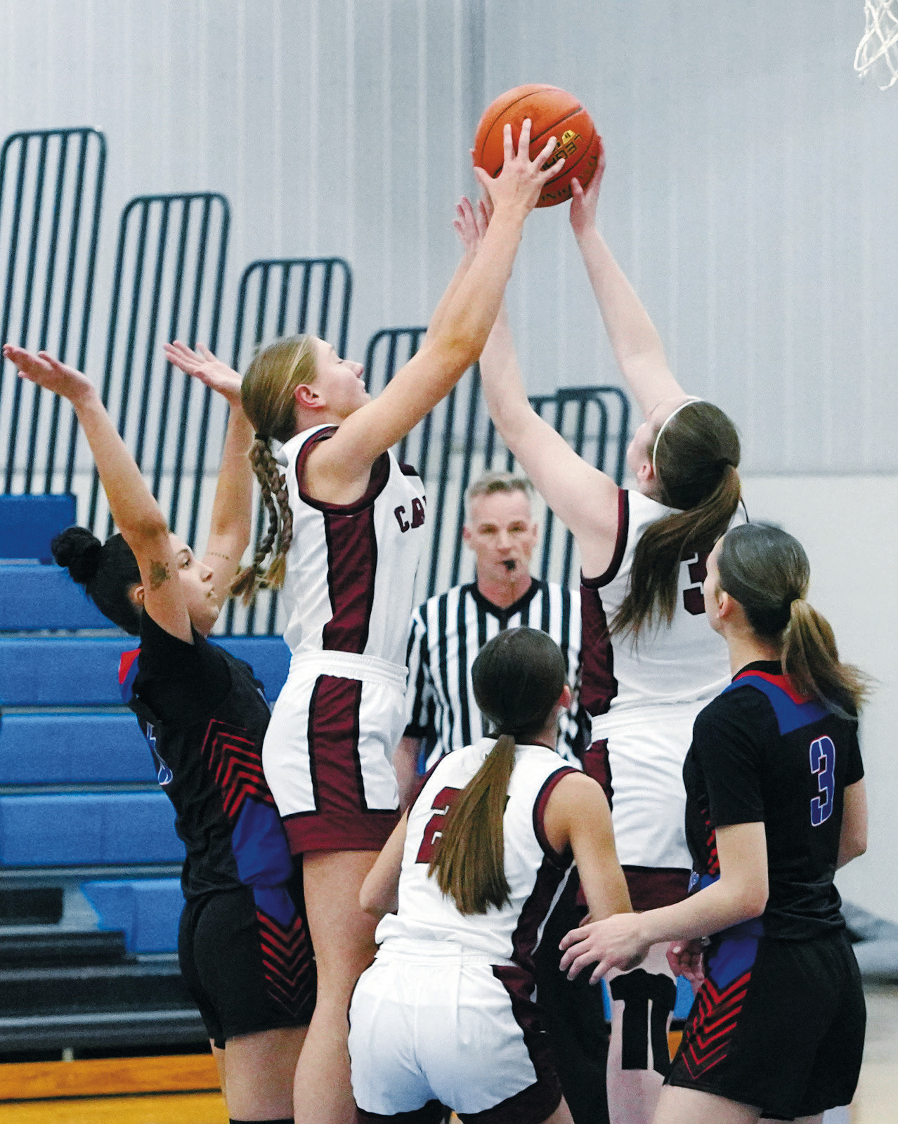 Aubrey Badding and Meredith Romfo both go up for a rebound in the Cards’ win over Dunseith. Photo by Larry Stokke.