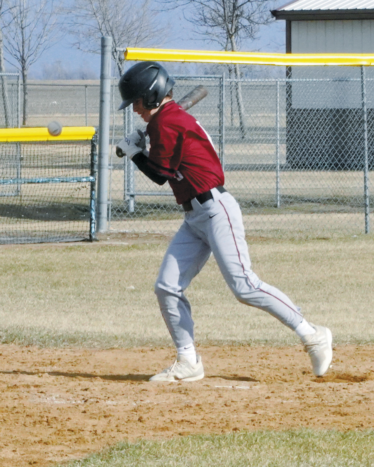 Connor Mitchel gets hits with a pitch and heads to first base in the game against Grafton. Photo by Larry Stokke.