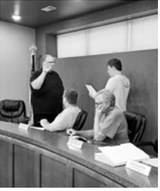 Commissioner Cody Schlittenhard is sworn in to his new term by city attorney Quentin Wenzel while Lawrence Henry and Charles Downs look on. Henry (president) and Downs (commissioner) also took their oaths of office at Monday’s commission meeting. Borderland Press photo