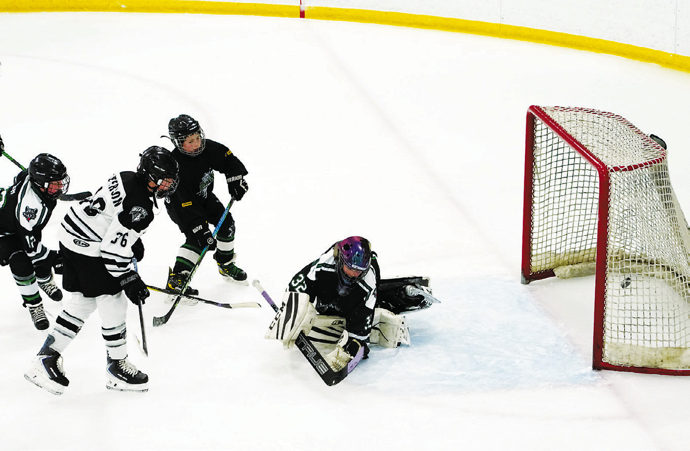 Ramsey Peterson sends the puck into the net to add to the Blades' 9-4 win over the JVC Prowl at the Dakota Spirit Arena on Saturday, Nov. 29. Photo by Larry Stokke.