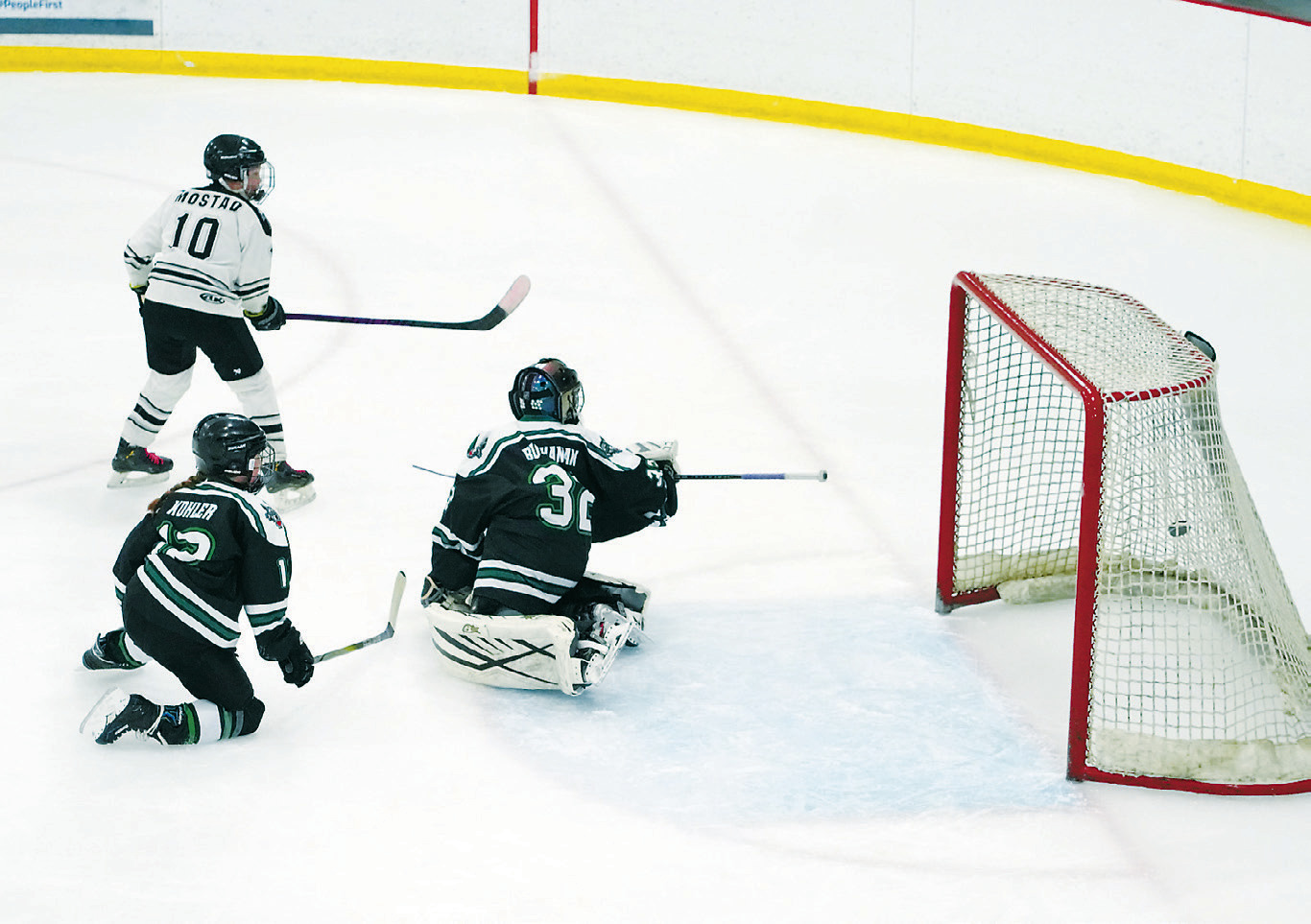 Merek Mostad shoots the puck past the JVC Prowl goaltender to score for the Blades. Photo by Larry Stokke.