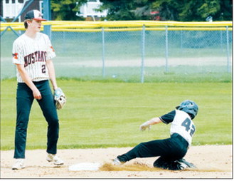 Collin Longtin kicks up a cloud of dust as he slides into second base during the Grizzlies' Region 4 Tournament matchup with the Mustangs. Photo by Larry Stokke