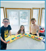 Griffy, Daxton and Ren showing off their colorful creations. Submitted photo