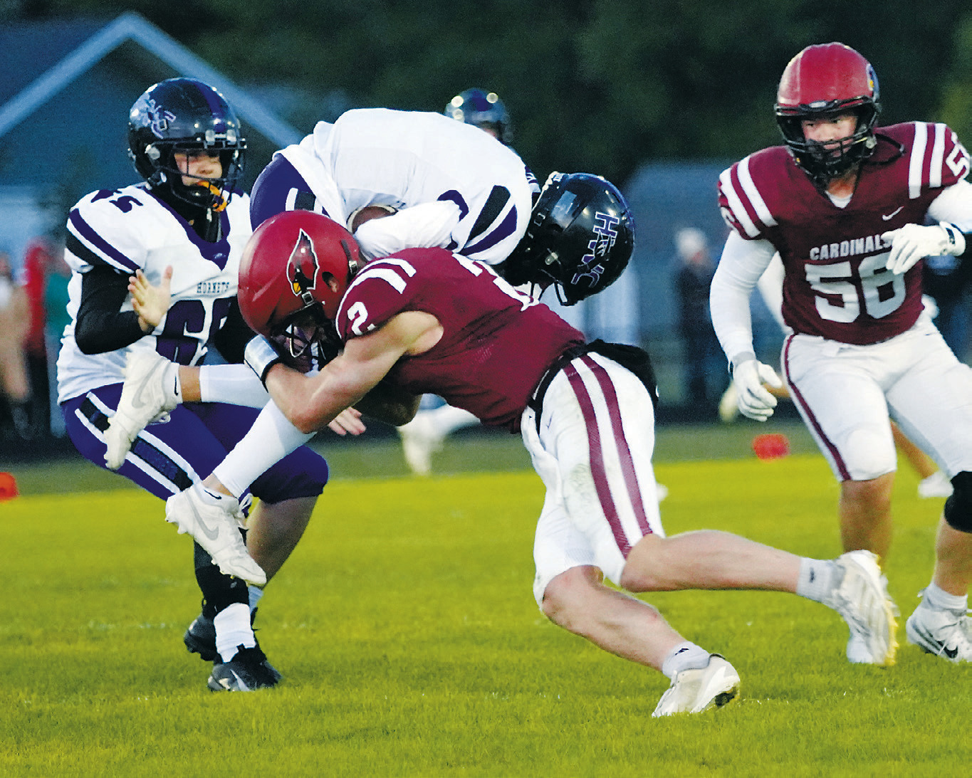 Jax Johnson tackles a Hornet ball carrier, taking him off his feet. Photo by Larry Stokke.
