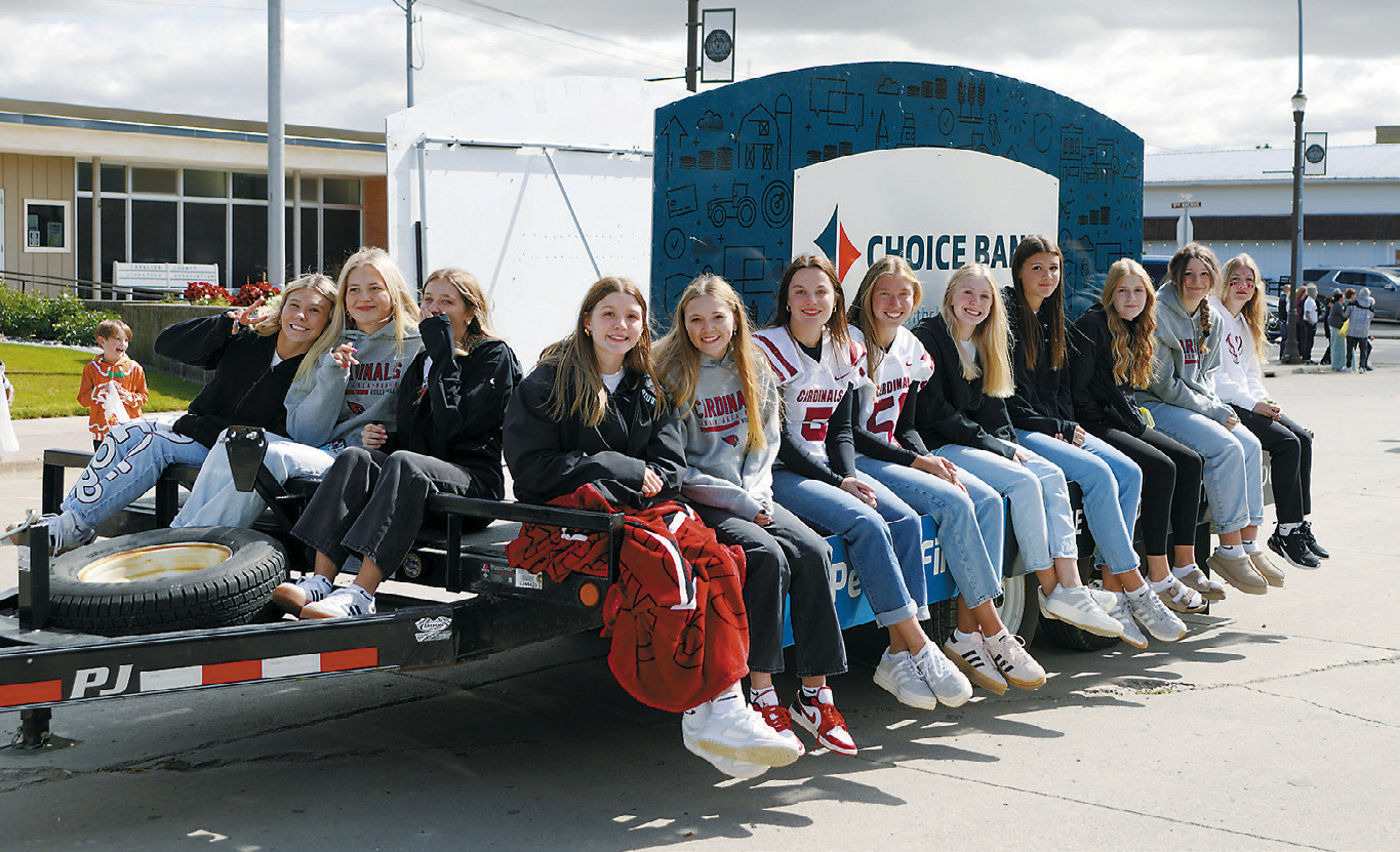 The high school girls put on a smile while riding their float in the Homecoming Parade last week. The Cardinal Football Team on their float in the Homecoming Parade. Photo by Larry Stokke. Photo by Larry Stokke.