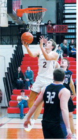 Tanner McDonald drops in a layup in the Cards win over Hatton-Northwood. Photo by Larry Stokke.