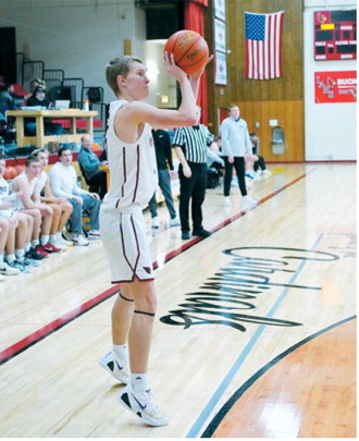 Caleb McDonald drops in a basket from beyond the 3-point line in the Cards win over Hatton Northwood. Photo by Larry Stokke.