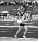Delaney Denault runs a leg of the 4x800-meter relay for Pembina County North. The team of Maci Puppe, Shirley Kemp, Delaney Denault and Emersen Helgoe placed fifth with a time of 10:04.60 at the NDHSAA Class B State Track and Field Meet. Photo by Ashley Schafer