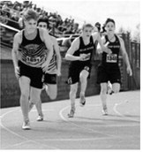 Boone Carrier hands the baton to Kylan Schafer during the 4x200-meter relay preliminaries. The Pembina County North team of Micah Dutch, Trevor Hilluka-Moore, Boone Carrier and Kylan Schafer finished 29th in 1:36.63 at the NDHSAA Class B State Track and Field Meet. Photo by Ashley Schafer