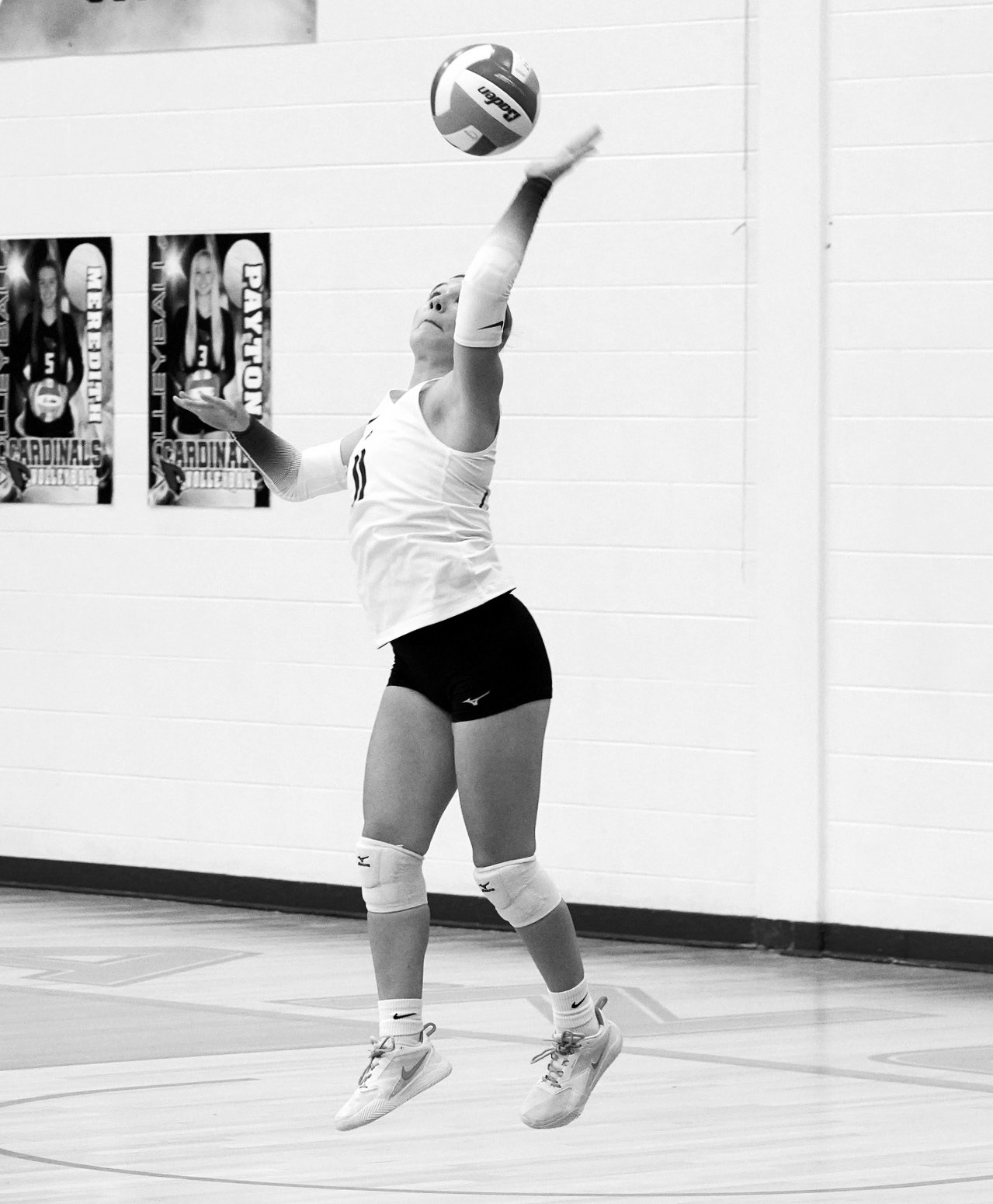 Raeleigh Ratzlaff serves up the ball against North Prairie. Photo by Larry Stokke.