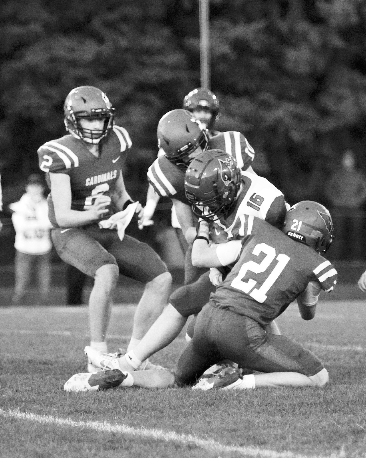 Eastyn Schafer and Maddux Stremick stop any yardage gain by Carrington's Rider Bickett. Photo by Larry Stokke.