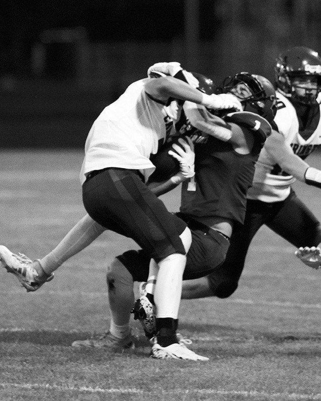 Jayden Lee tackles a Carrington ball carrier. Photo by Larry Stokke.