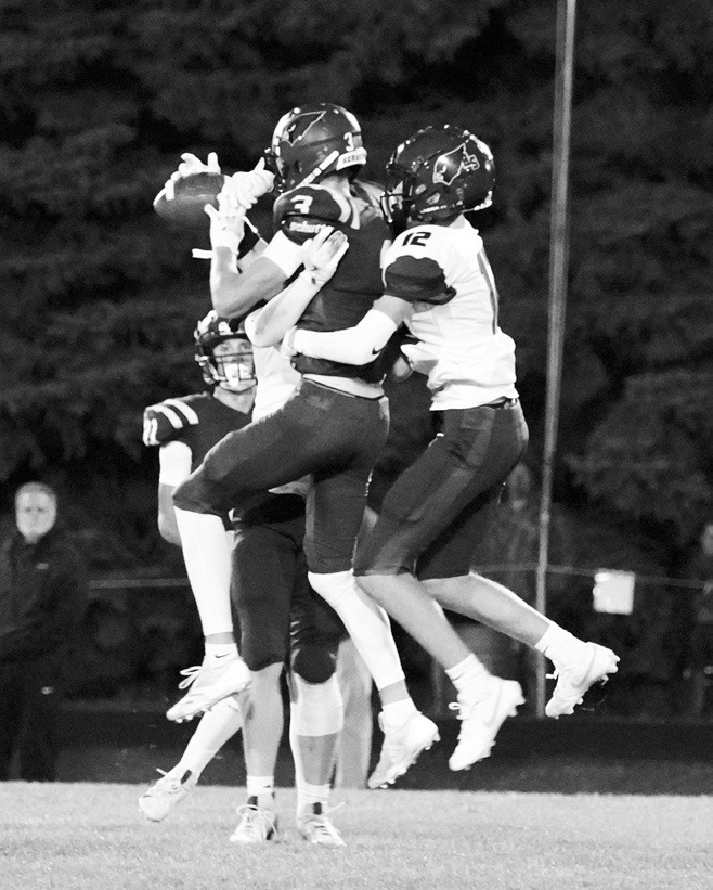 Cody Amble makes a great catch under pressure and hangs on to the ball for a first down. Photo by Larry Stokke.
