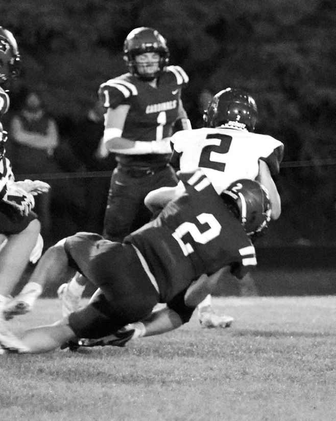 #2 Jax Johnson tackles Carrington's #2 Josh Bickett for a loss of downs. Photo by Larry Stokke.