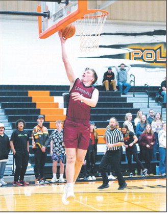 Levi Swanson drives in on a fast break and drops in one of his 9 points in the Cards win over Larimore on Jan 3. Photo by Larry Stokke.