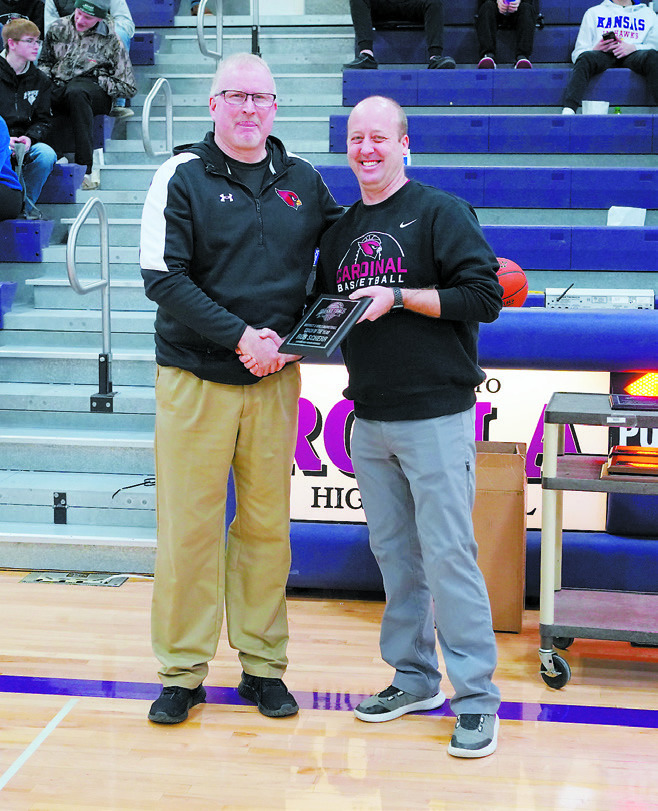 Ethan Askvig (right) awards Rob Scheer (left) who was chosen by his peers to be District 3 Coach of the Year. Photo by Larry Stokke.