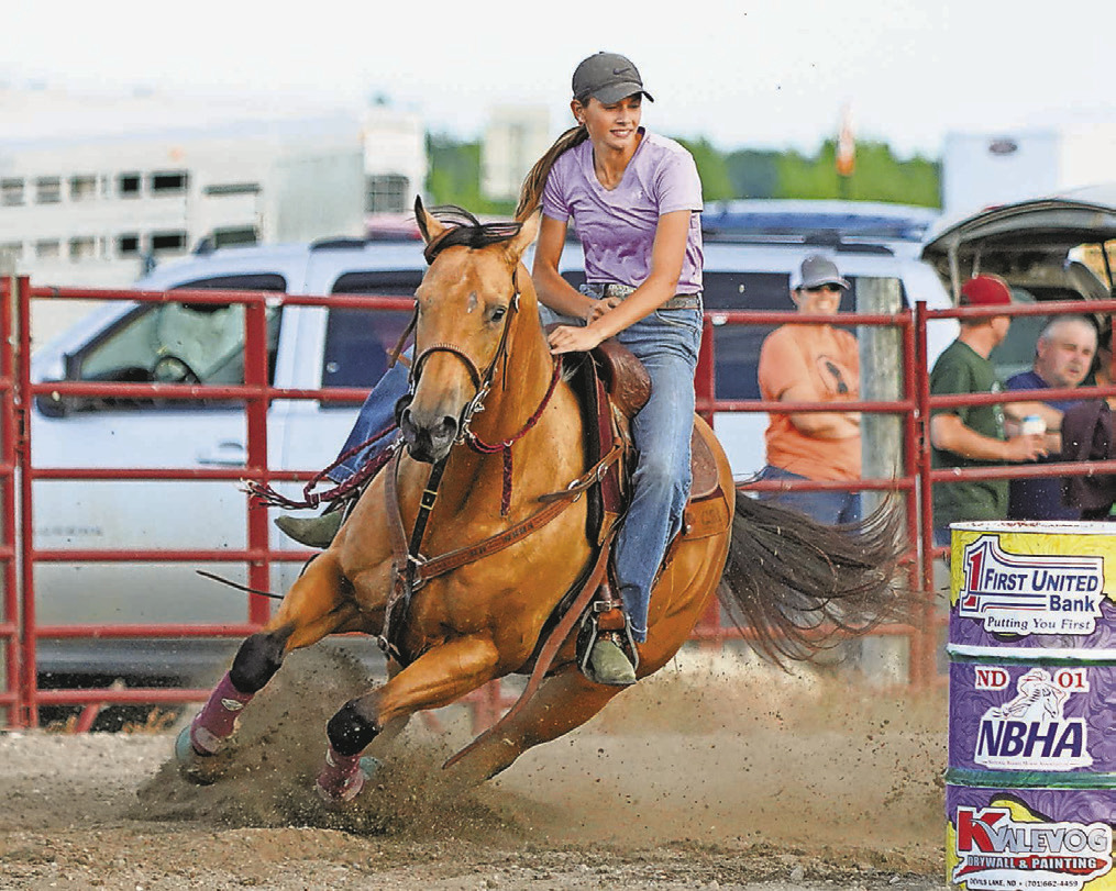 Jezimay Watson gets a fast corner around the second barrel on her horse Birdie in Devils Lake on June 24.