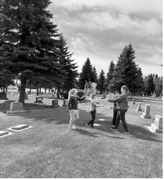 Members of the Prairie Rose 4-H Club, their families and veterans from the Langdon American Legion gathered before placing flags at area cemeteries in preparation for Memorial Day observances. Volunteers assisted with the annual effort to honor veterans and show respect for those who served their country.