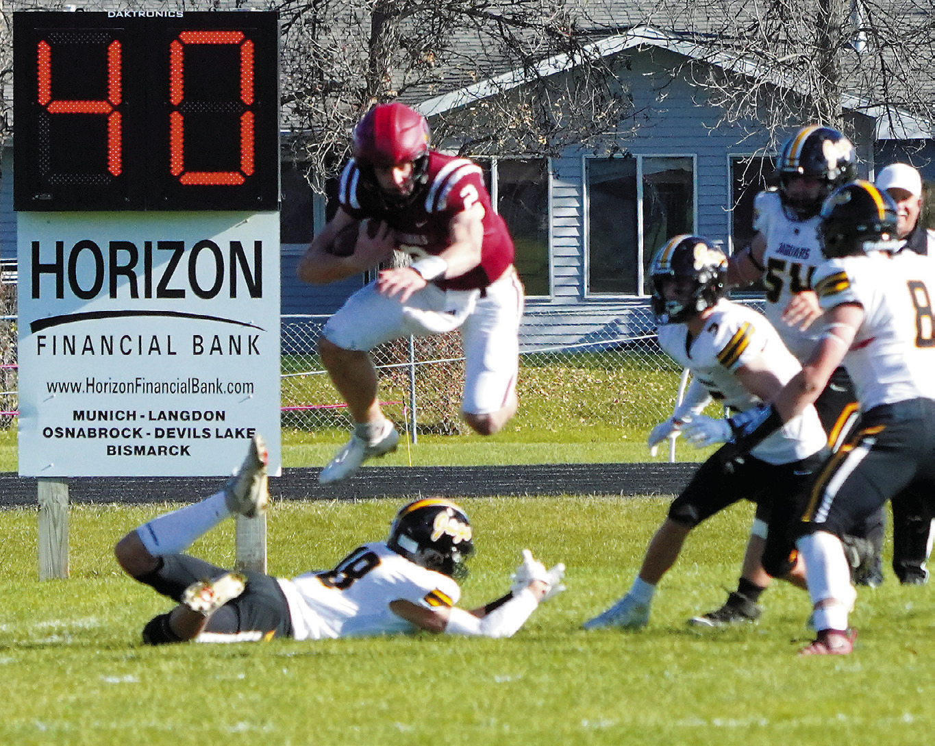 Jax Johnson hurdles over a Jaguar defender to add to his 128-yard rushing day. Photo by Larry Stokke.