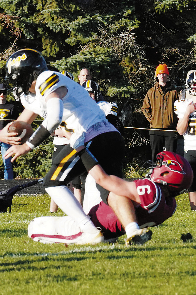 Braxton Lindseth gets his hands on a Jaguar and stops him from making a first down in the Cards' win over Northern Cass. Photo by Larry Stokke.
