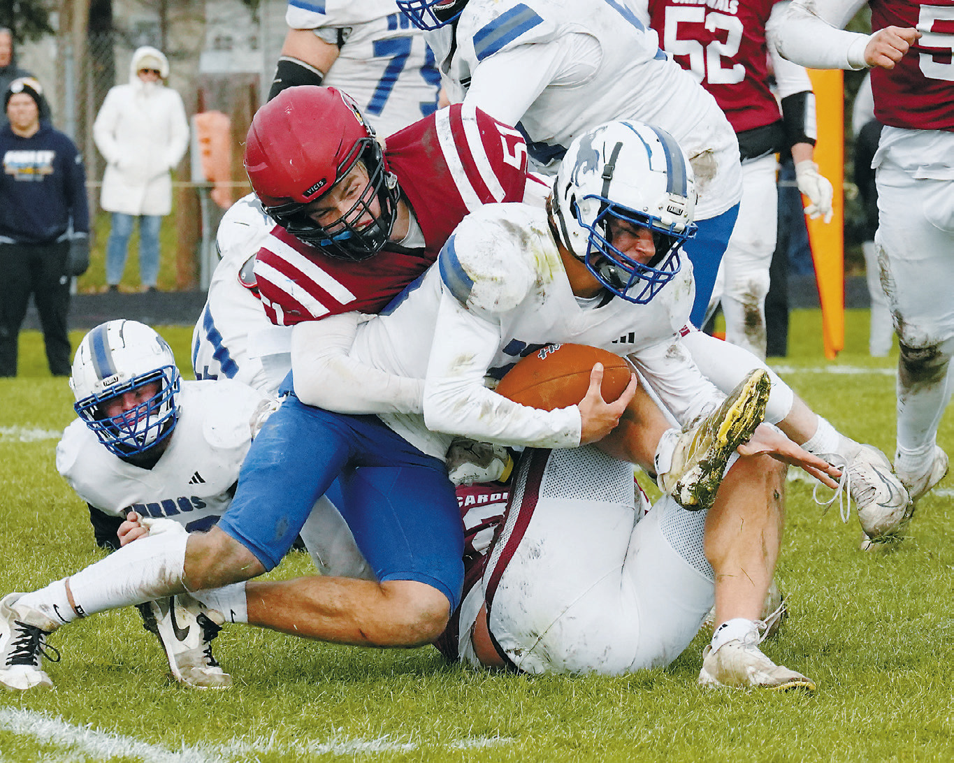 FM State Bank's Player of the Game Keaton Ullyott, with help from Theo Romfo, tackles the Burros quarterback, Tyson Leshuk. Photo by Larry Stokke.