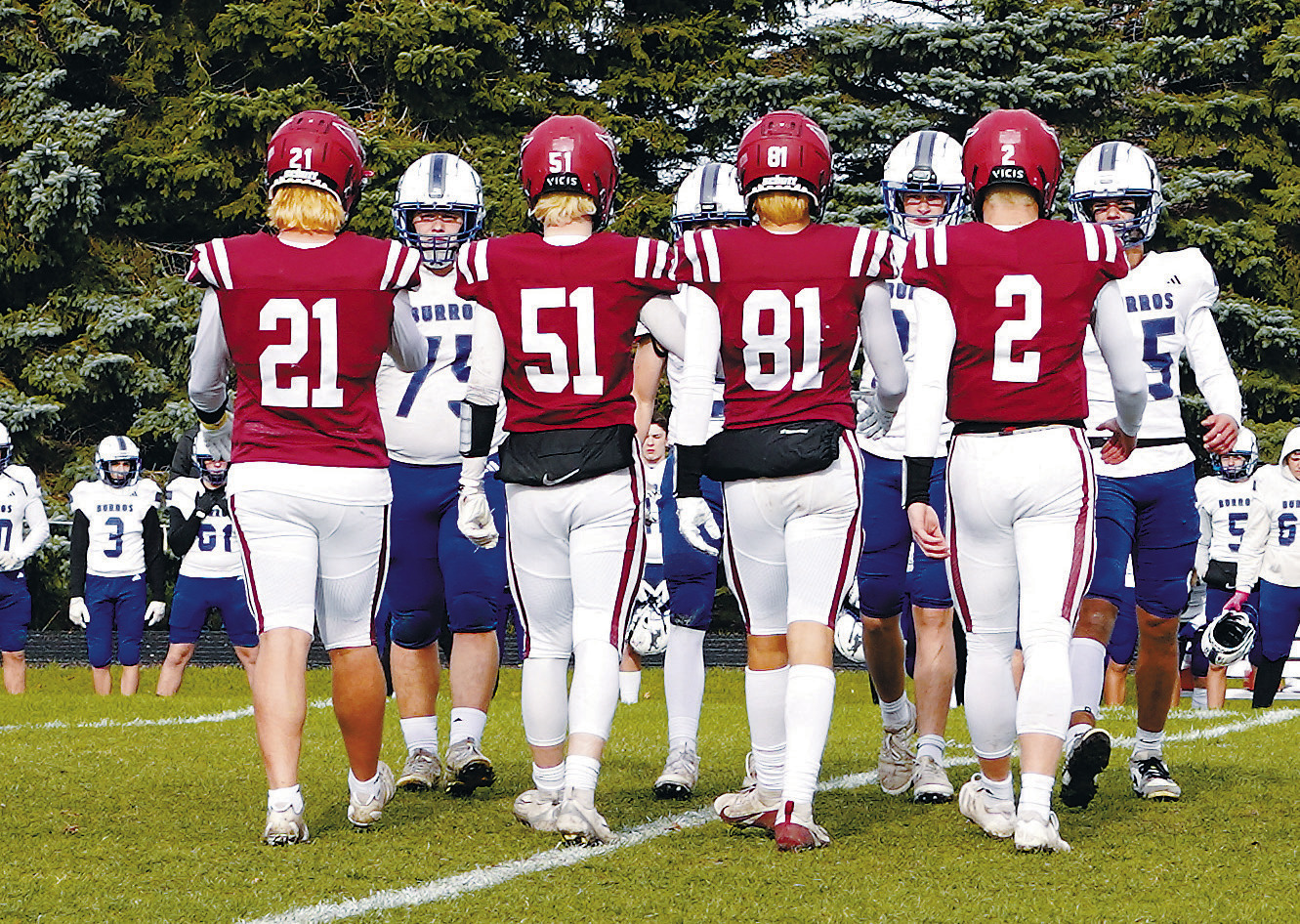 Seniors (L-R) Theo Romfo, Keaton Ullyott, Tanner McDonald, and Jax Johnson meet at the center of the field before the game with the Hillsboro Burros captains. Photo by Larry Stokke.
