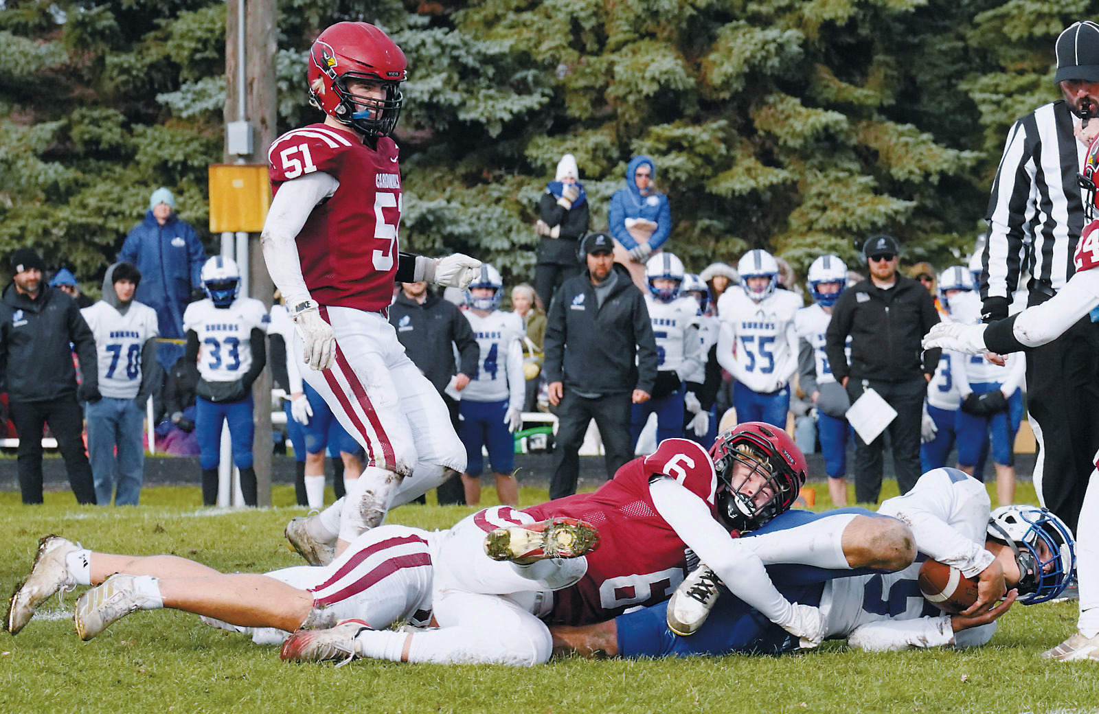 Braxton Lindseth tackles a Burros ballcarrier for a turnover in downs. Photo by Larry Stokke.