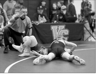 Dannika Bennett pinned her girl in 63 seconds and is heading to the State Meet in Fargo. Photo by Larry Stokke