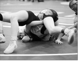 Charlotte Crowston pinned her girl in 27 seconds, assuring her of a place at the State Meet. Photo by Larry Stokke