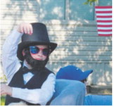 Abe Lincoln (Henry Soli) throws candy to the crowd during Langdon’s first annual Pre-Blast Bash parade. Photo by Larry Stokke