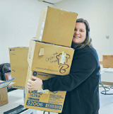 Kayce Schlittenhard sees just how many boxes she can carry. It’s all about efficiency! Photo by Gwen Zorn.