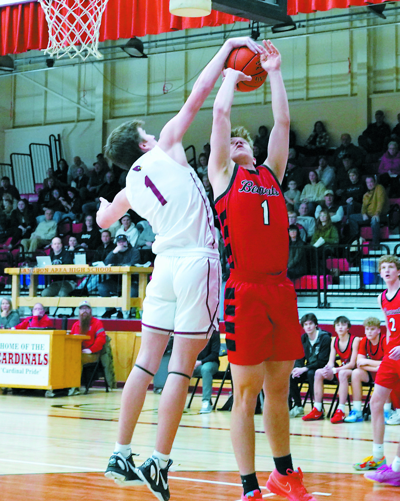 Eastyn Schaefer blocks a shot by the Bearcat's Alec Peyerl. Photo by Larry Stokke.