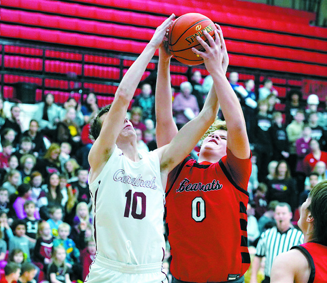 Maddux Stremick fights for a rebound with North Star's JD Dupreez. Photo by Larry Stokke.