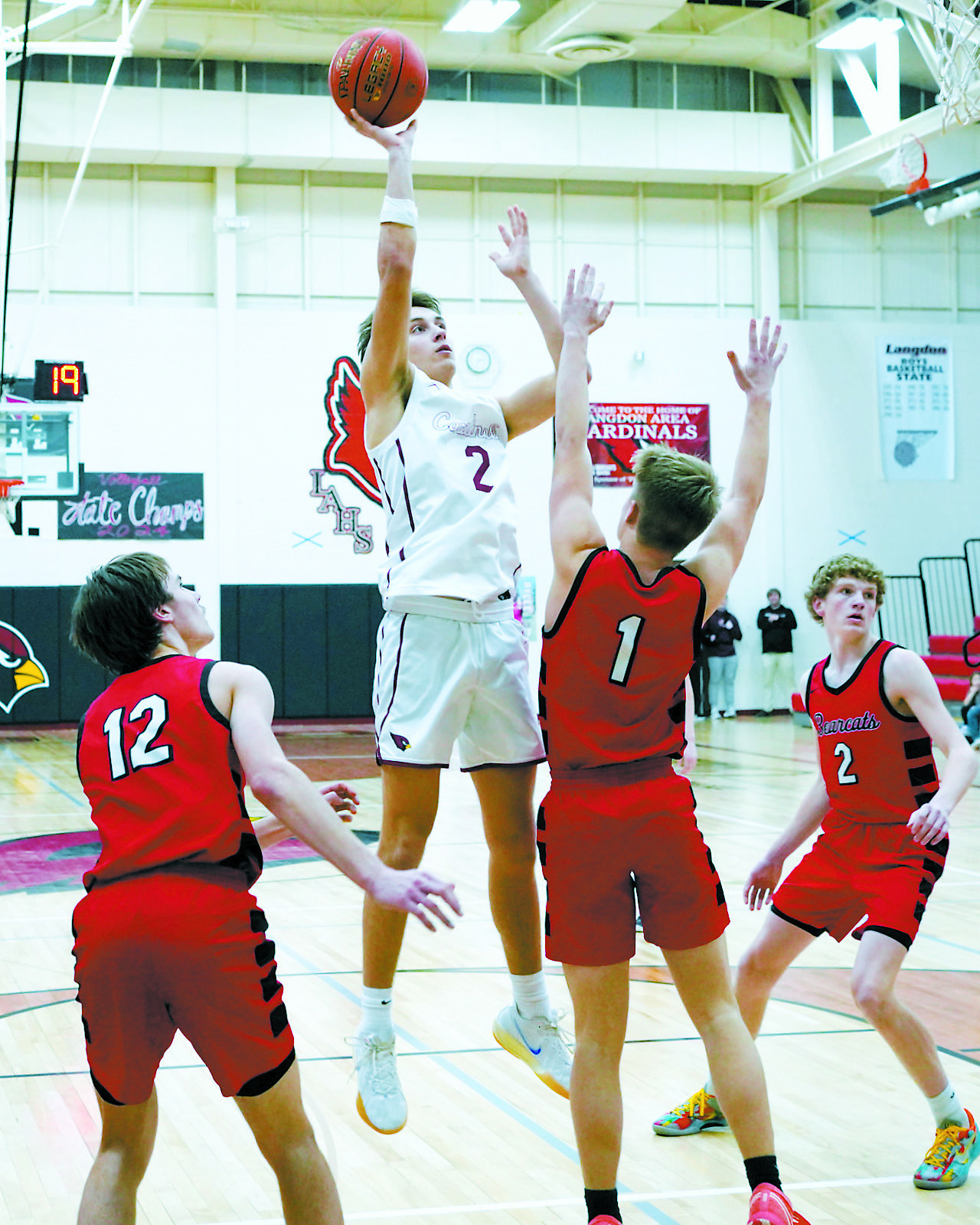 Tanner McDonald buries a shot, shooting over a Bearcat in Langdon on Feb. 7. Photo by Larry Stokke.