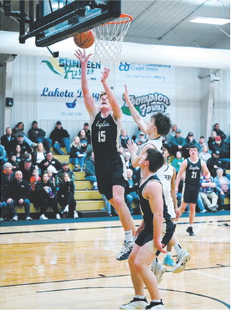 Eagles’ Garret Willits goes up for a layup against his defender in the game against Nelson County. Photo by Ashley Schafer