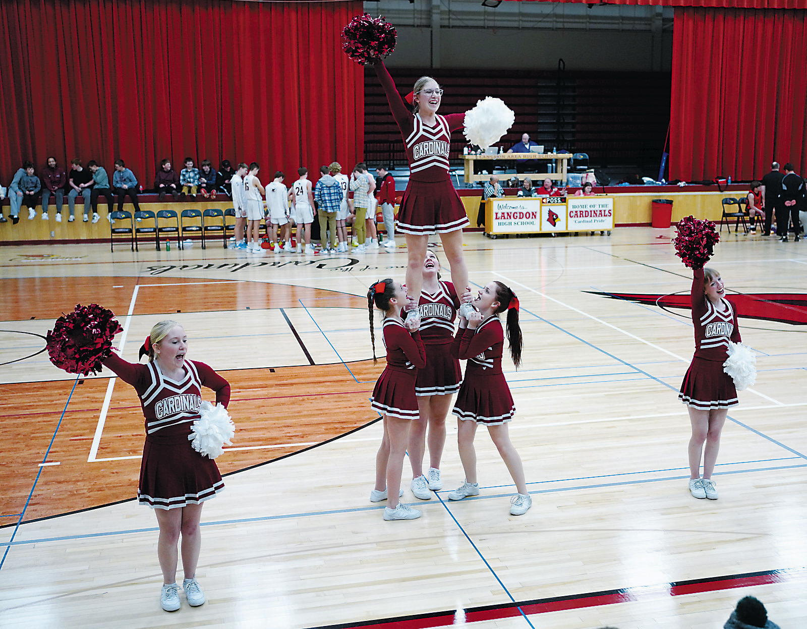 Cardinals Cheer Team did some stunting to keep the fans entertained and cheering. Photo by Larry Stokke.