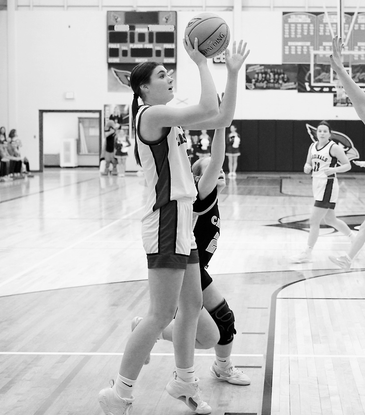 FM Bank’s Player of the Game Taya Feist gets fouled on her shot, sending her to the free throw line where she completed a three-point play. Photo by Larry Stokke.