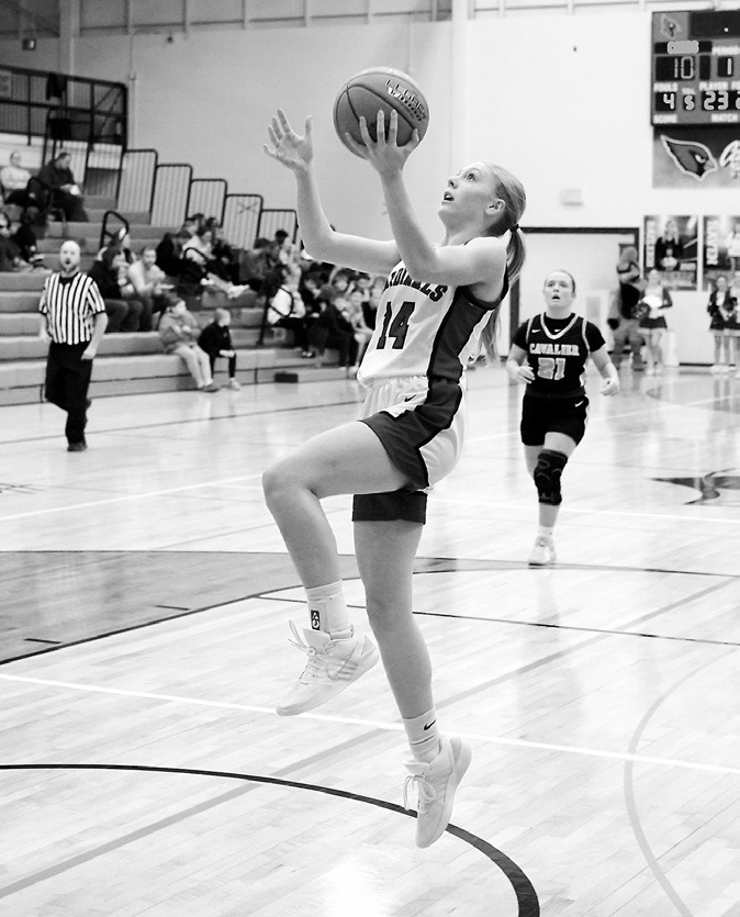 Hilary Haaven with a fast break and a lefthanded layup to finish the Cards' win over the Tornadoes on Dec 11 in Langdon. Photo by Larry Stokke.