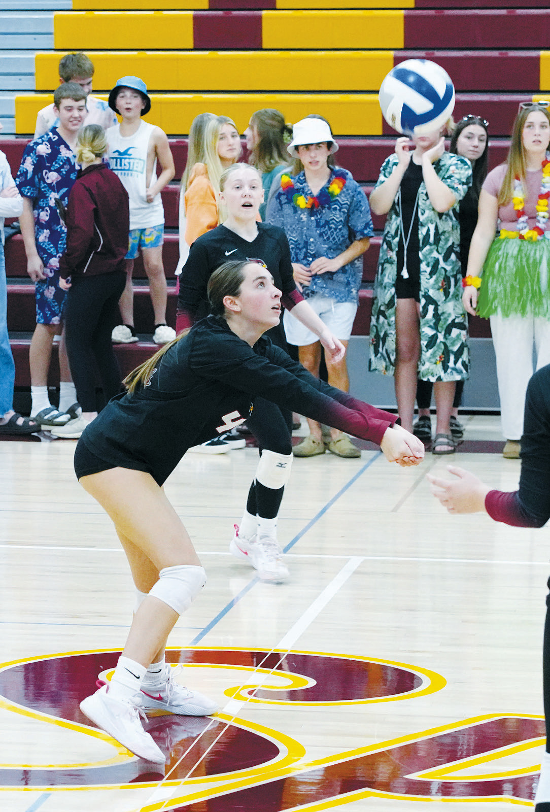 Avery Lorenz passes the ball to the front row in the Cards 3rd set out of 5 for a win over the Spoilers. Photo by Larry Stokke.