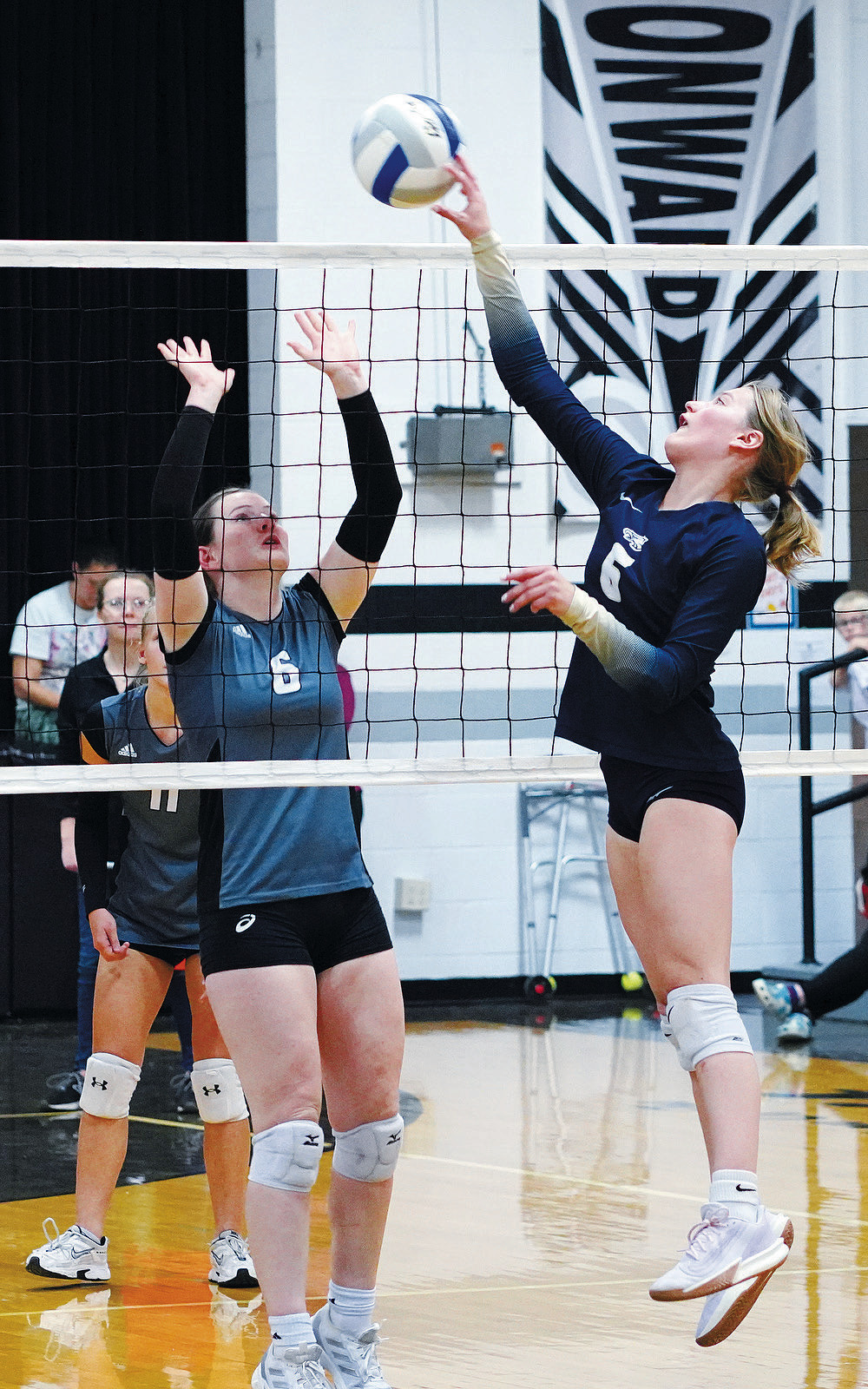 Dannika Bennett sends the ball over for a point against the Titans. Photo by Larry Stokke.