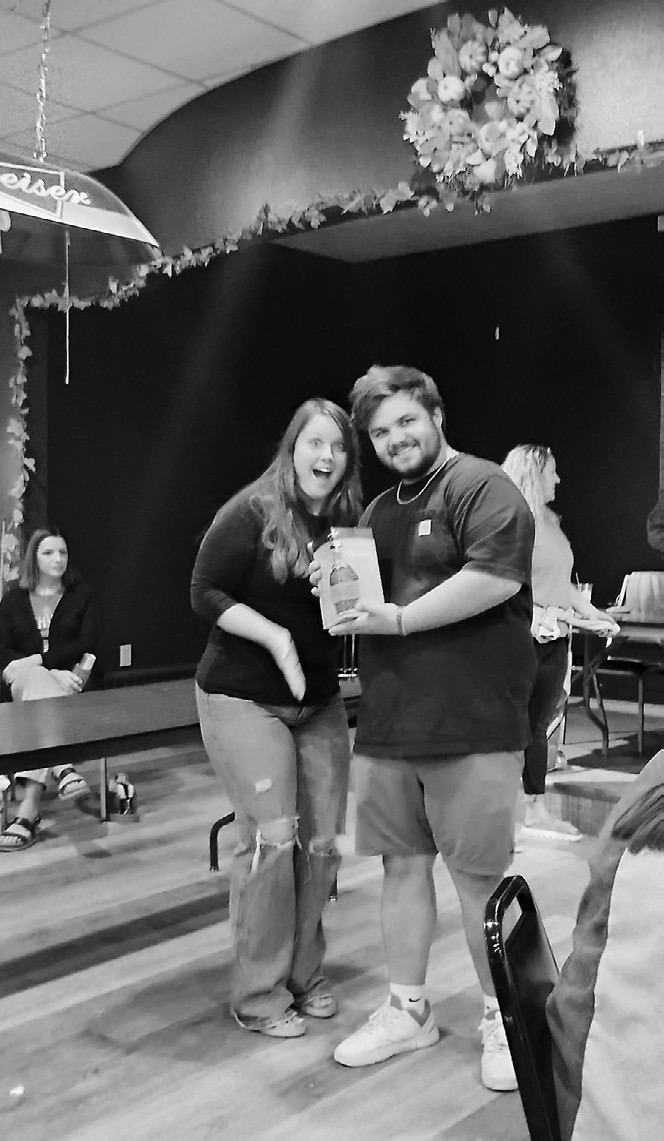 Brandi Mittleider and Alex Cluchie, who was the winner for the Blanton Bourbon raffle prize donated by Sip Happens and the Langdon Area Chamber of Commerce.