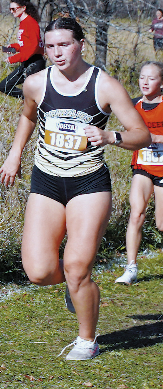 Delaney Denault placed 52nd with a great run at the state meet in Jamestown. Photo by Larry Stokke.