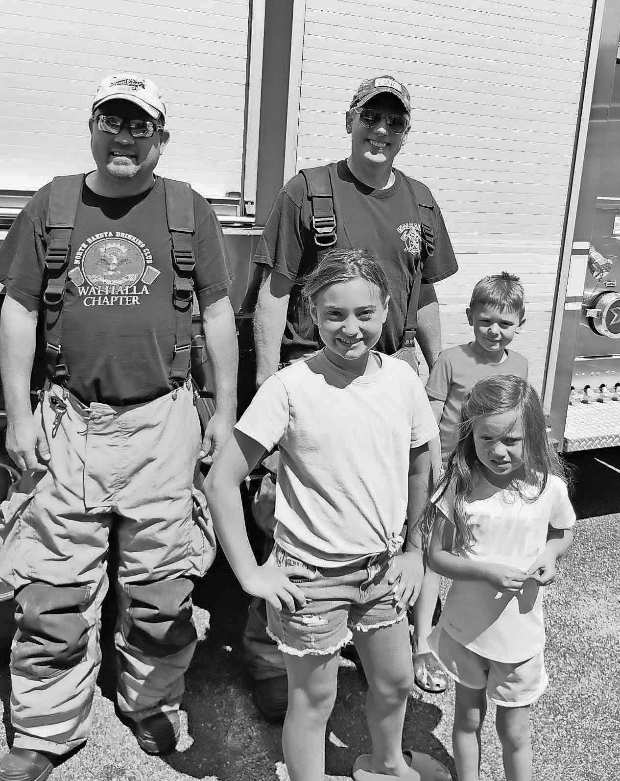 Vivienne Chaput, Mauri Chaput and Walker Smith pose with Jerad Berg and Jeff Sims during the library’s Summer Reading Program.